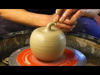 Making. Throwing a ceramic clay pottery Apple on the wheel
