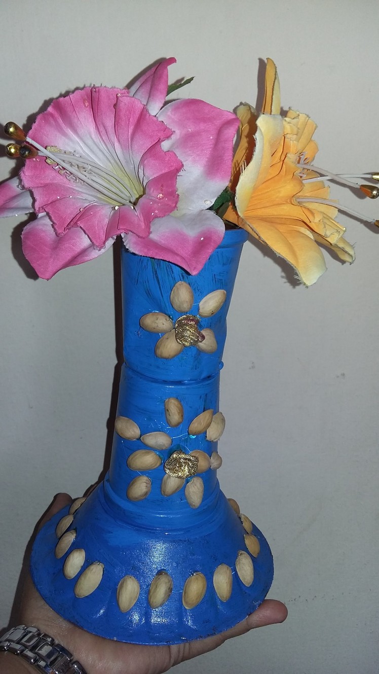 Plastic glasses & pista shell flower vase