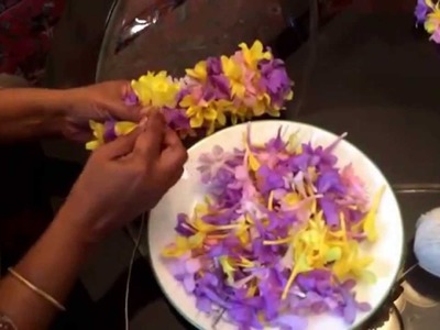 Making an Indian flower garland. Gajra with flowers.  One of the popular way of making a lei. 