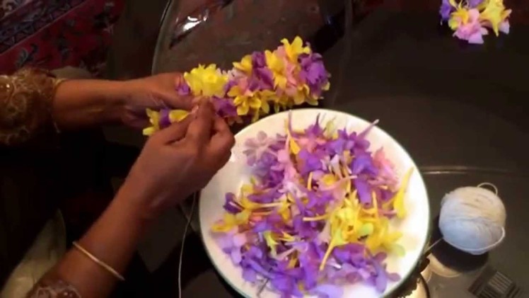 Making an Indian flower garland. Gajra with flowers.  One of the popular way of making a lei. 