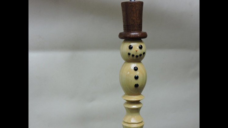 Wood turning a snowman ornament