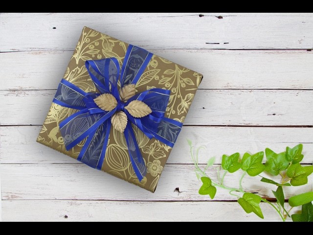 Creative Gift Wrapping using brown gold-foil paper and blue sheer ribbon