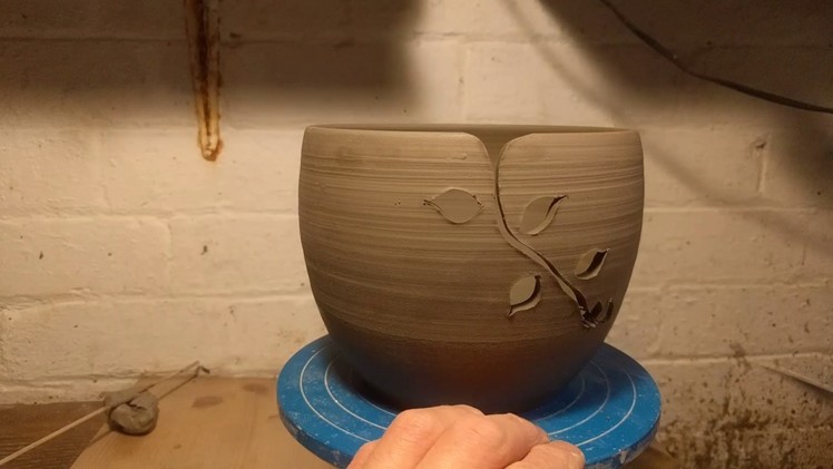 Carving a leaf pattern into yarn bowls. Making handmade pottery in my home studio