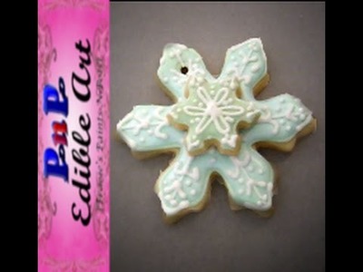 Snowflake sugar cookie ornament decorated with royal icing