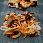 Hand crocheted baby mocasins with matching headband.