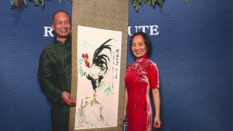 Henry Li painting a rooster scroll for Duke Argyll