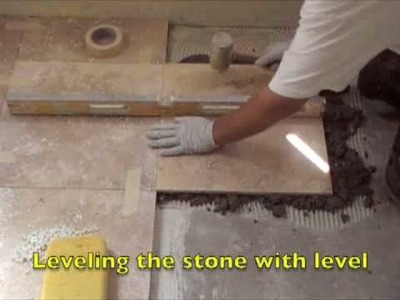 Installing a stone floor using a float method.