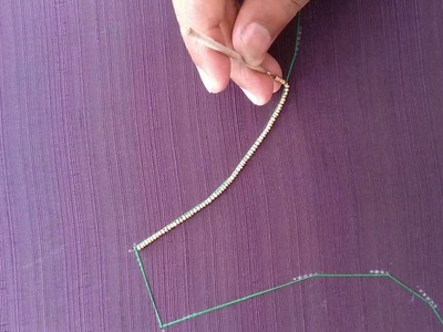 Creating the outline for a blouse using beads