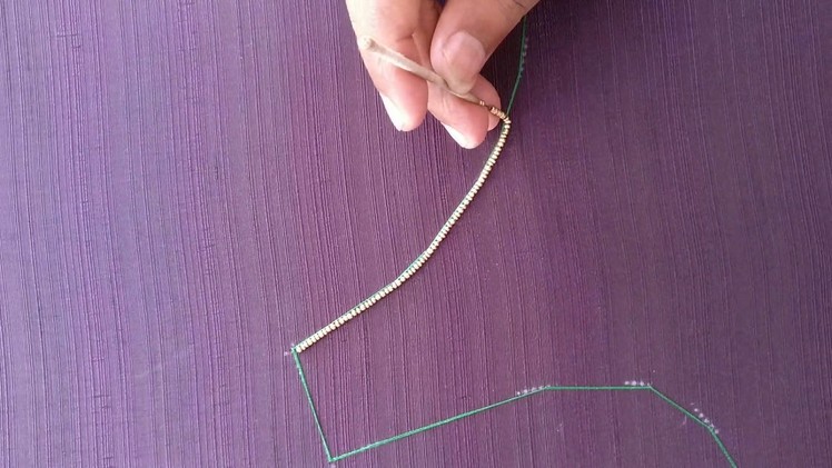 Creating the outline for a blouse using beads