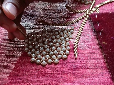 Placing sugar beads among big white pearls