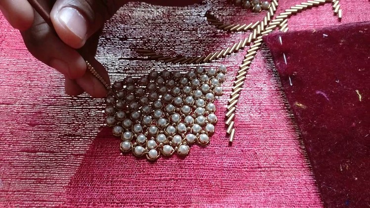 Placing sugar beads among big white pearls