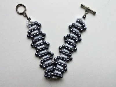 SIMPLE BEADED PATTERN for BEGINNERS. A bracelet of white seed beads and black pearl beads.