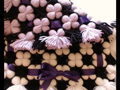 Pom pom blanket.  LOOK a reversible 3D puffy flower blanket or pom pom rug