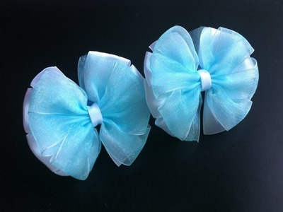 The decoration on the elastic hairband Kanzashi. Bows on the template from satin and organza