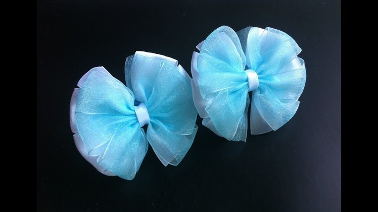 The decoration on the elastic hairband Kanzashi. Bows on the template from satin and organza