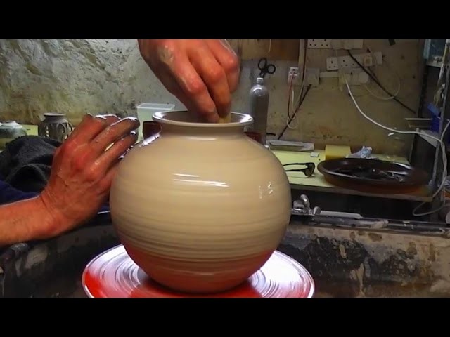 Throwing. Making a Round Pottery Vase on the Wheel
