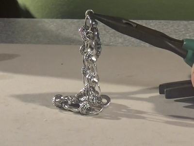 Soldering a charm on a bracelet with a solder gun