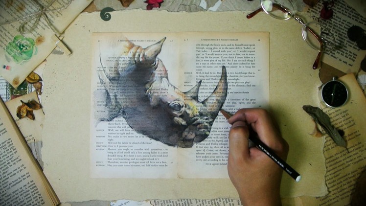 Drawing rhinoceros on old book pages - JayArt