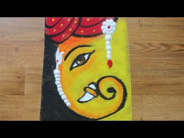 Colourful Ganpati rangoli with pagadi or pheta