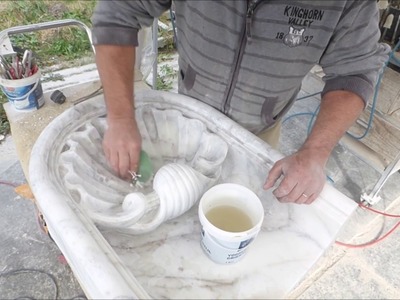 Carving a Venus shell in marble