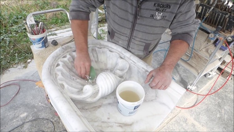 Carving a Venus shell in marble