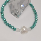 Cultured freshwater keshi pearl with teal green and frosted white beads on a stretch elastic thread bracelet