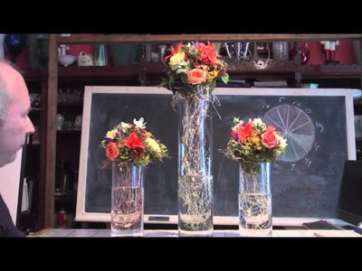 Party Floral Art on Glass Columns With Wire Collars and Foam Spheres