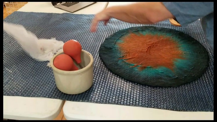 Hand felted vessel with cutaway resist