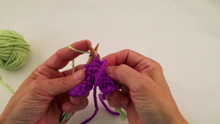 Joining yarn on purl side, holding yarn in left hand.