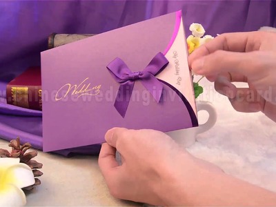 Fashionable wedding invitation card with purple ribbon