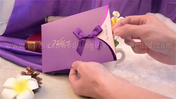 Fashionable wedding invitation card with purple ribbon
