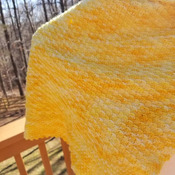 Hand knit asymmetrical shawl in hand dyed brilliant yellow of cashmere, merino wool and nylon blend.