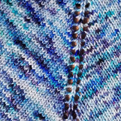 Hand knit sparkly shawl in stelina nylon and merino wool in variegated shades of blue.