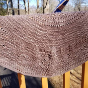 This lovely knit shawl is made of hand dyed 100 percent merino wool. It is lightweight but will keep off the chill beautifully.