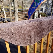 This lovely knit shawl is made of hand dyed 100 percent merino wool. It is lightweight but will keep off the chill beautifully.