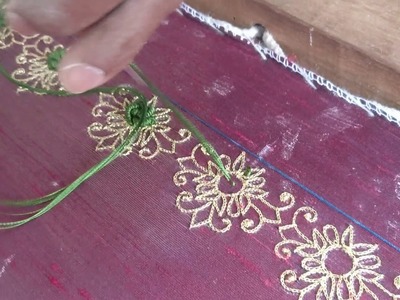 Can you name the embroidery technique used to create the green flower