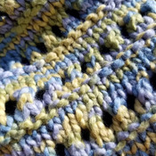 Lovely spring hand knit shawl in blue, green and yellow.