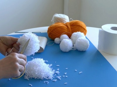 Making pom poms using toilet paper roll core