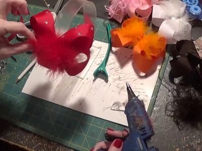 Adding bling and feathers to hair bows