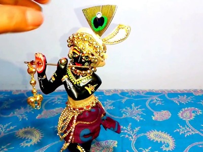 Decorate Krishna with golden beads. . . 