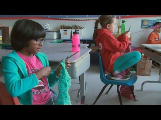 Young students learn to knit warm scarves for the homeless
