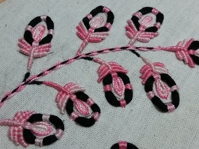 Hand embroidery of pink and black flowers with thread rings and bullion stitch