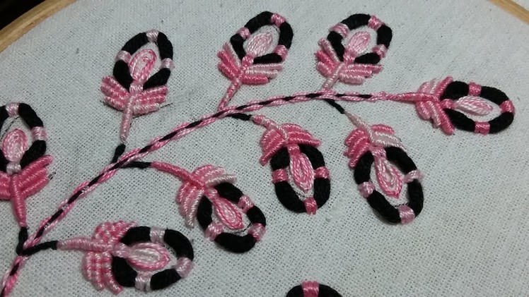 Hand embroidery of pink and black flowers with thread rings and bullion stitch