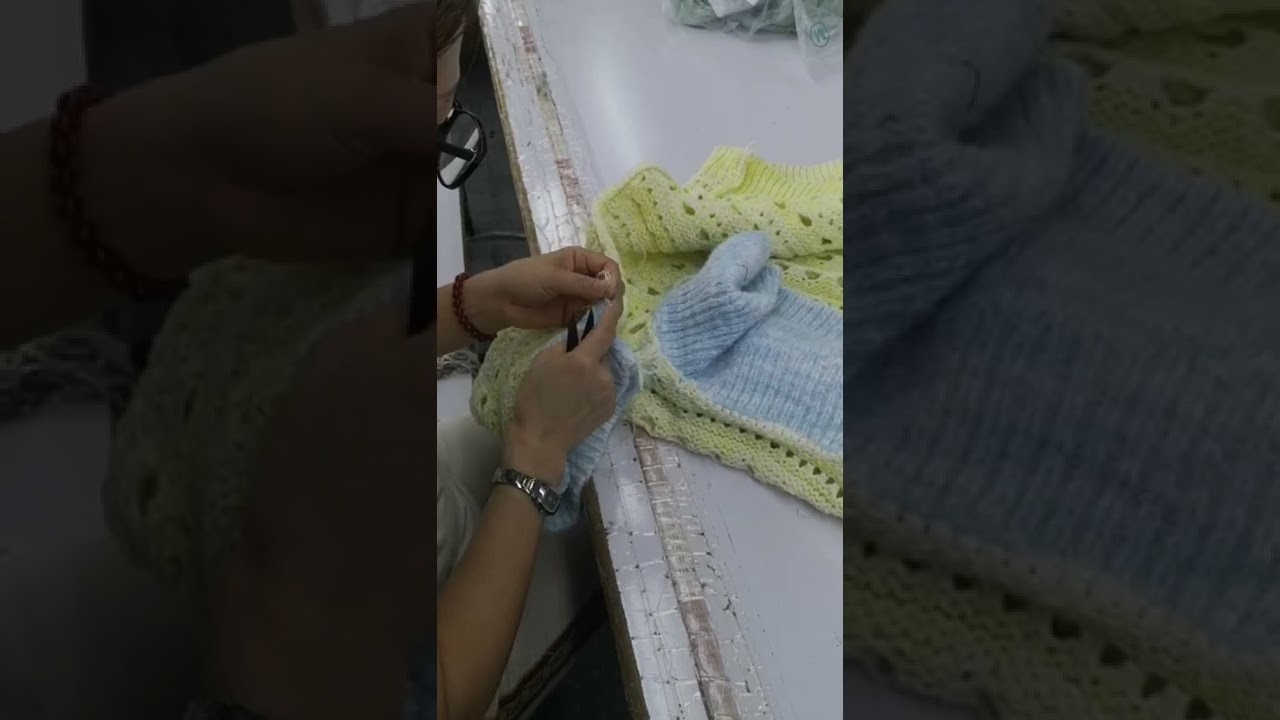 Workers are meticulously sewing