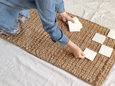 Lay squares of paper on a rug for this brilliant decor hack!