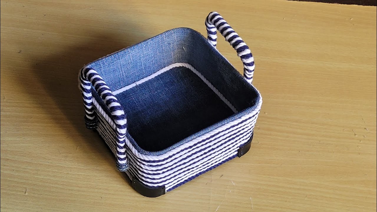 A small beautiful macrame basket made out of a plastic container and a jeans cloth piece.❤️