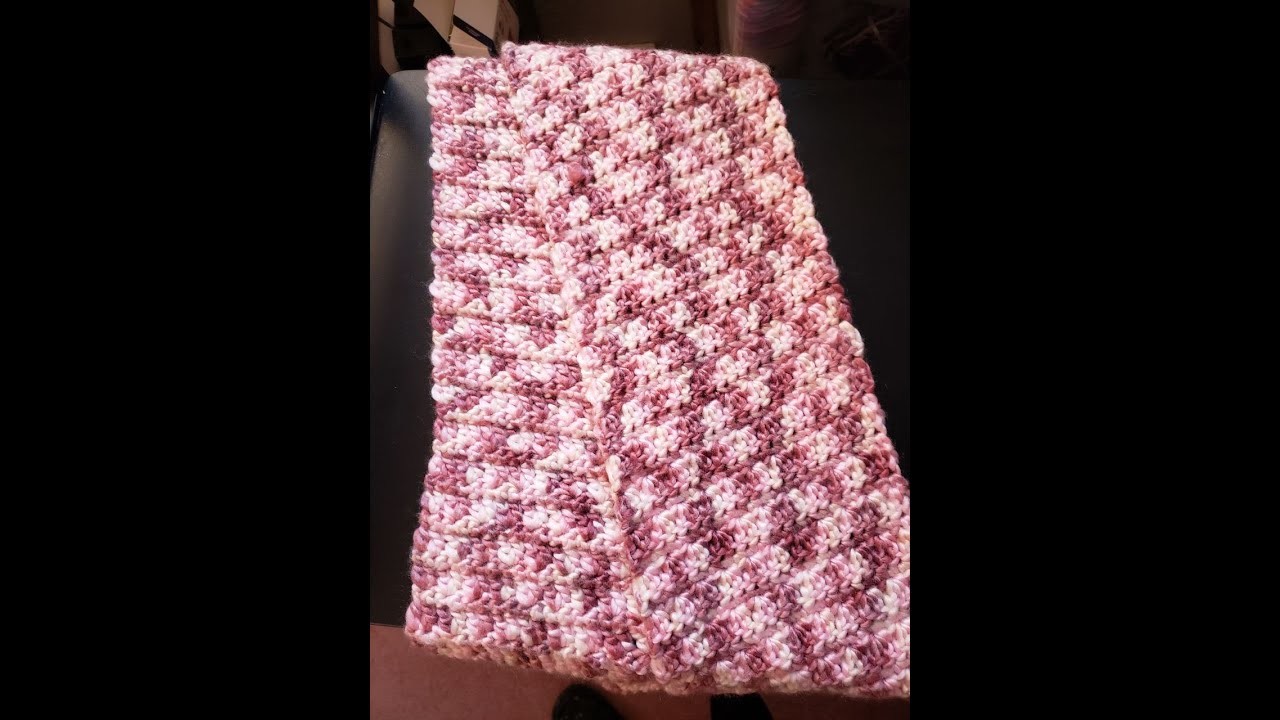 Crocheting eco cozy watercolors scarf, which is made from recycled plastic.