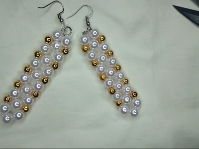 Making a unique earrings. Handmade pearl bead earrings.