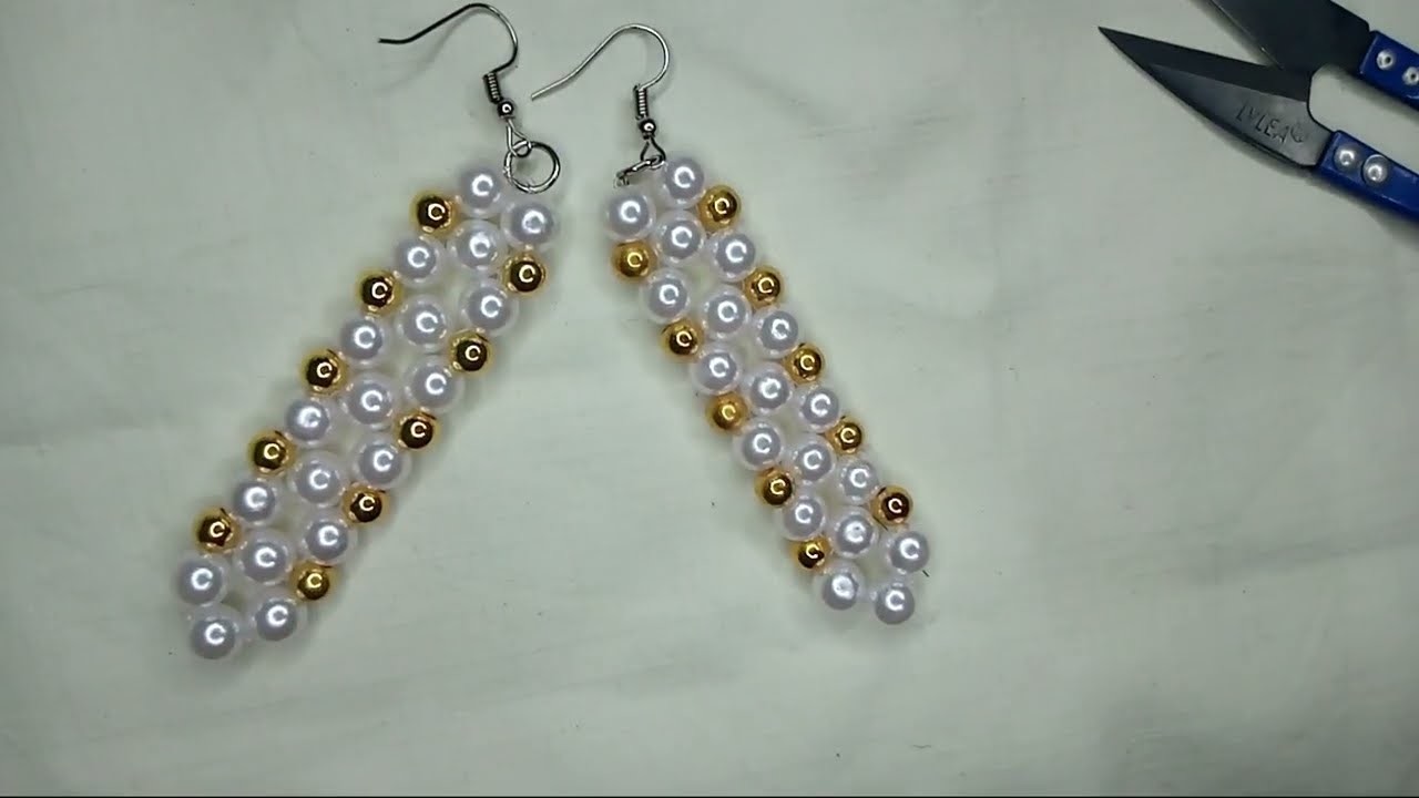 Making a unique earrings. Handmade pearl bead earrings.