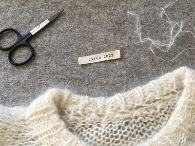 How to sew a label on a knitted sweater